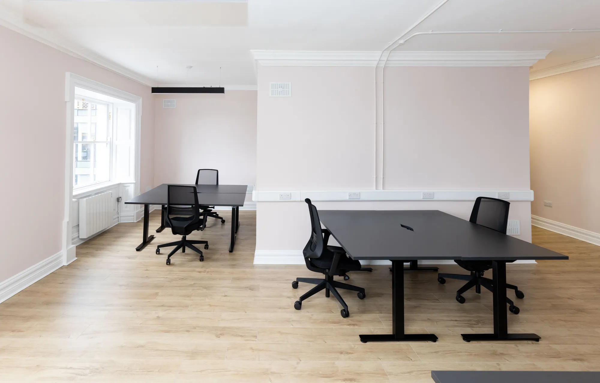 A private office with desks either side of the chimney breast