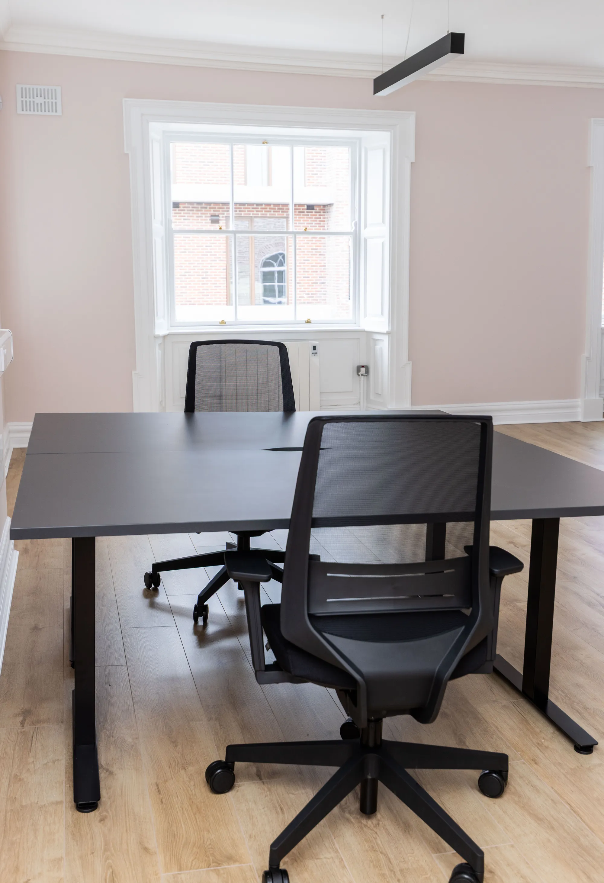 A desk pod in a blush private office