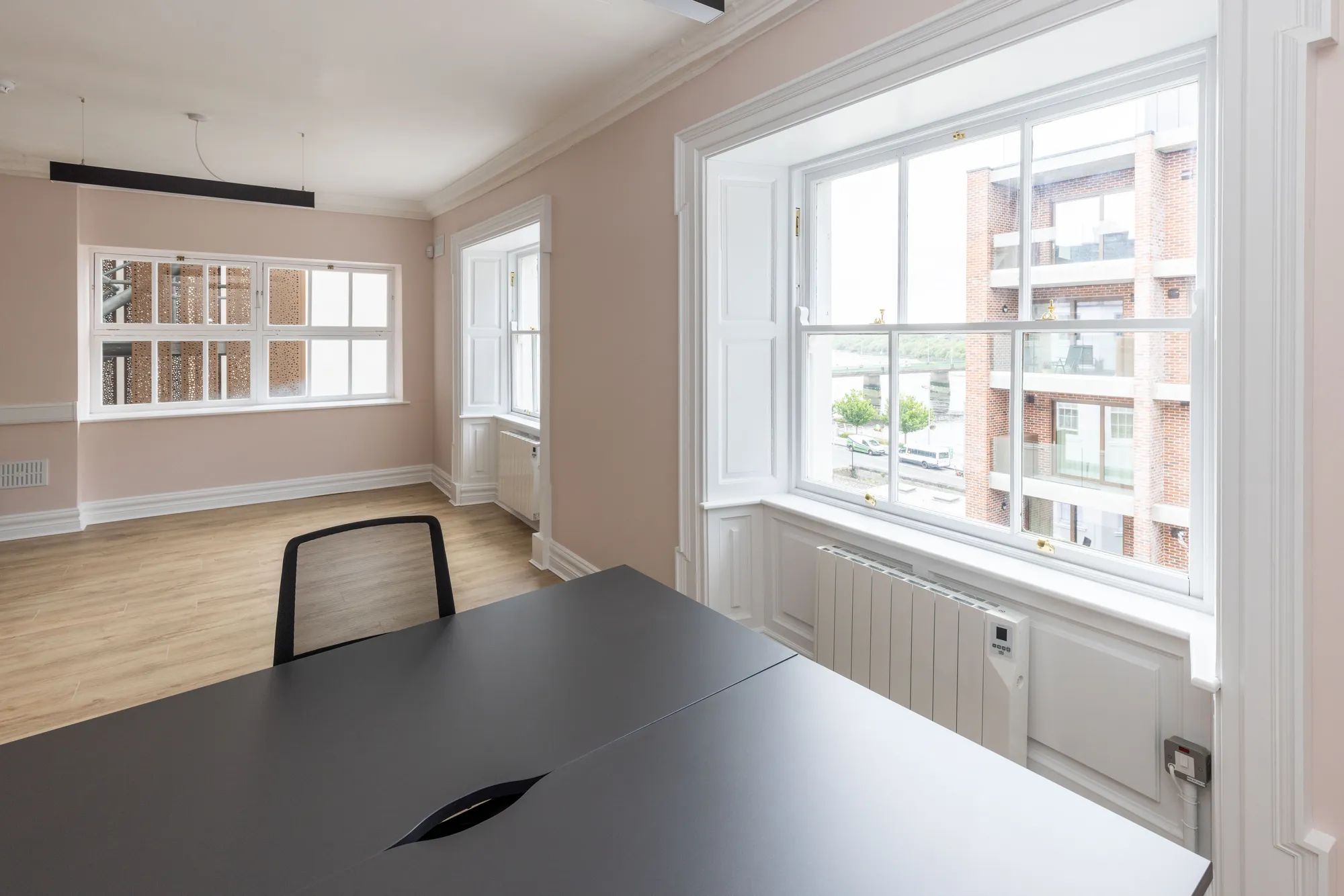 A desk by a large window looking over the city