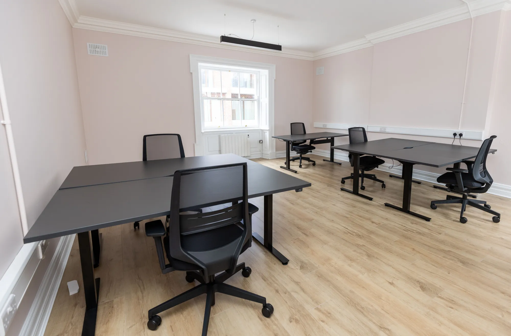A private office with two desk pods