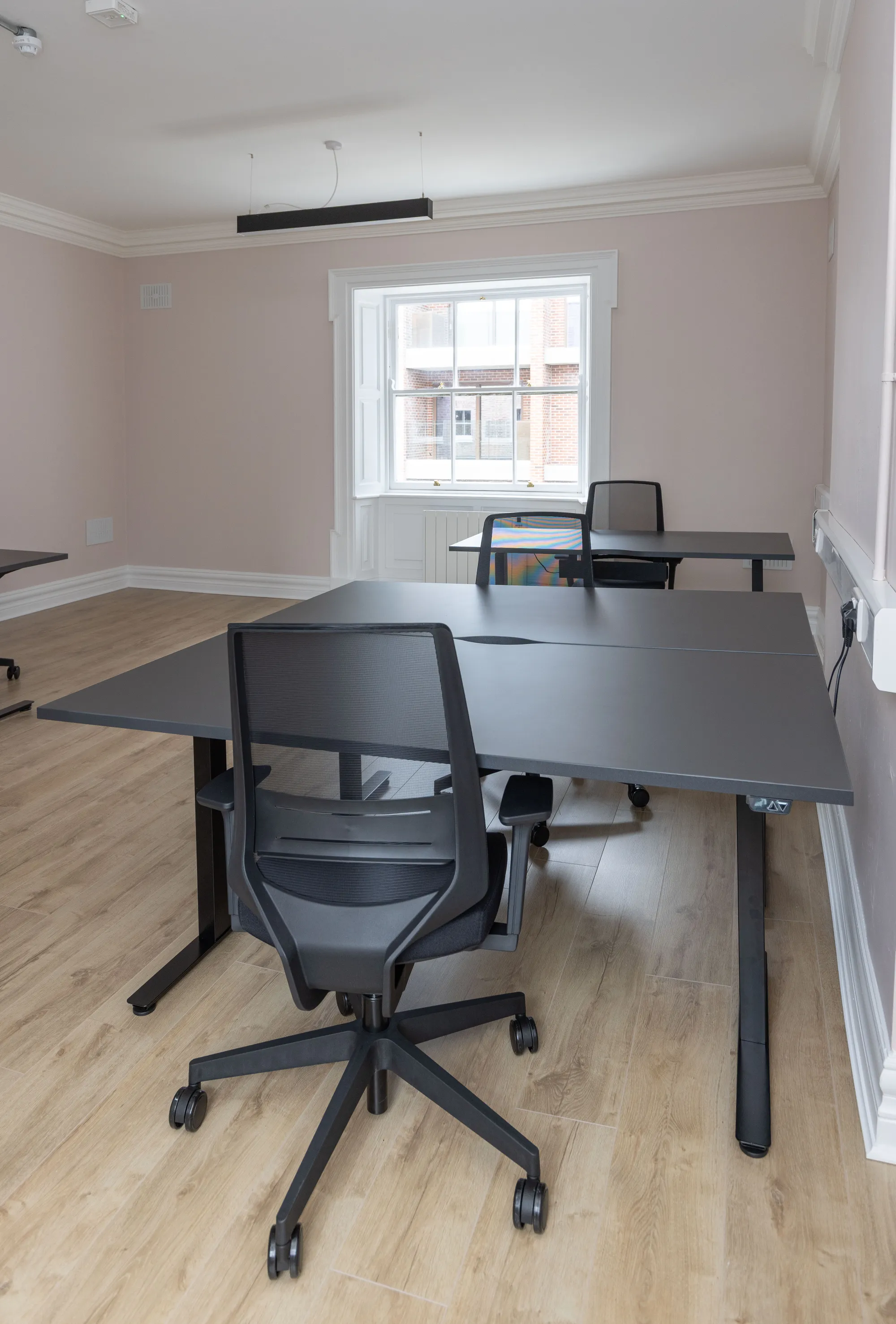 A desk pod by a sash window