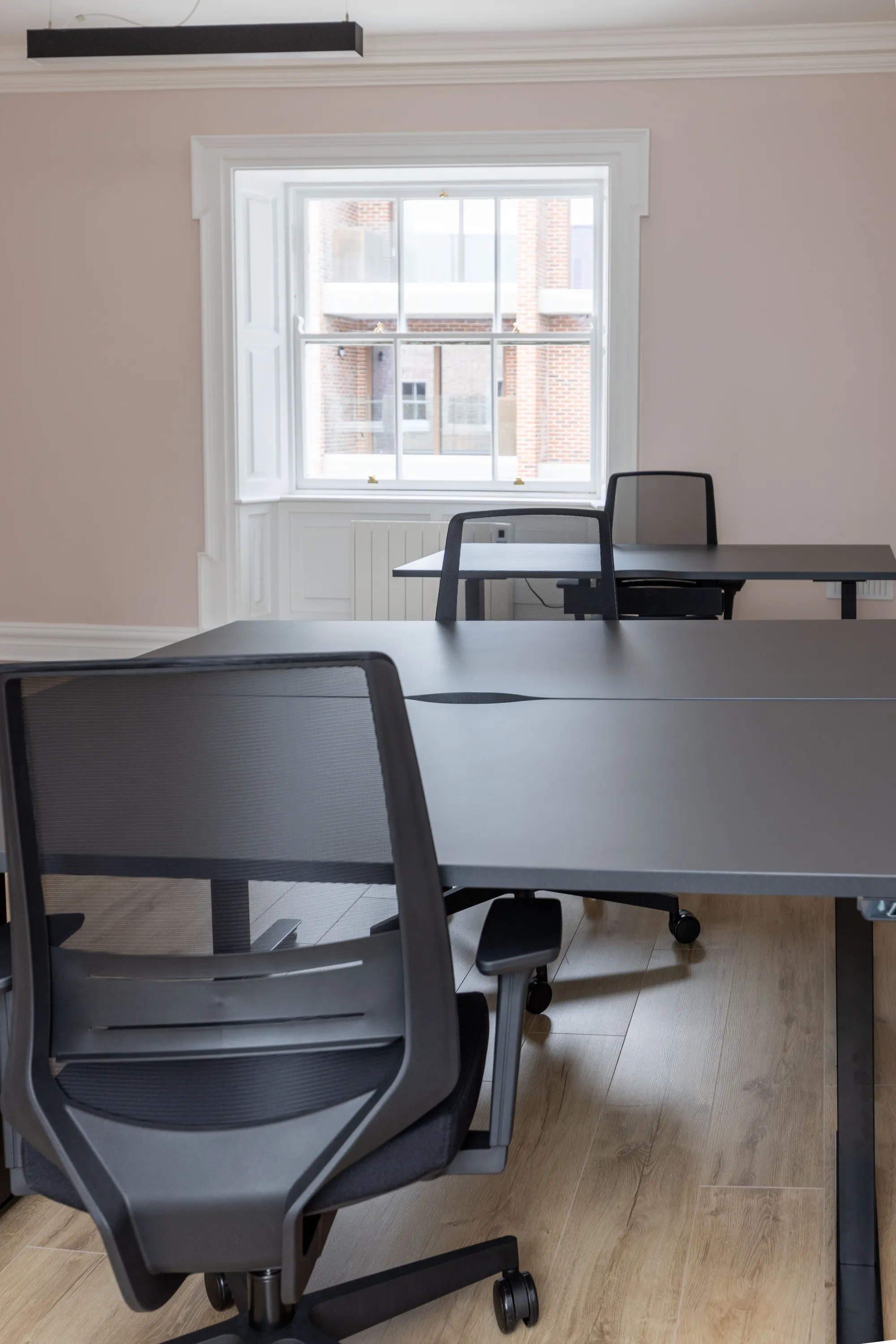 A mesh office chair at a desk