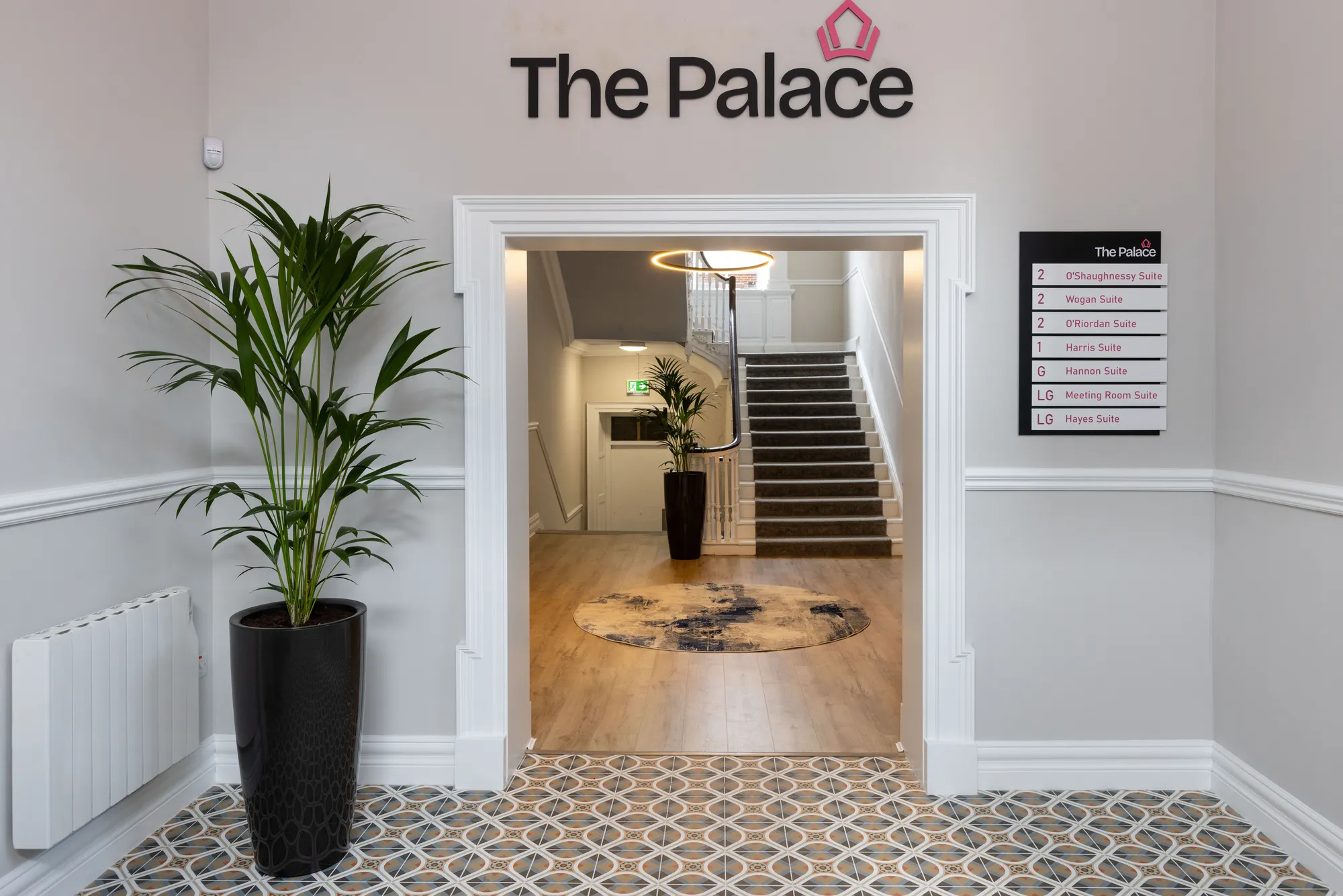The entrance hall with The Palace sign and the staircase beyond