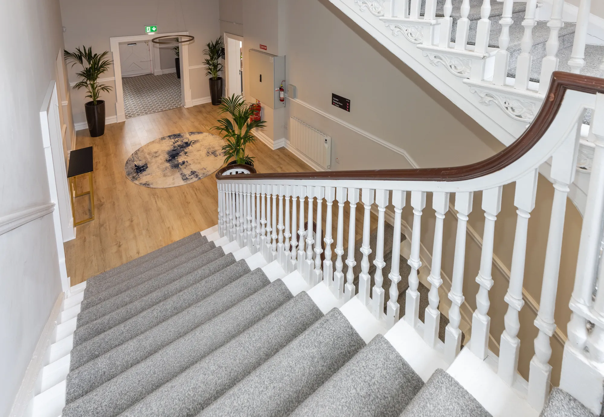 The curved handrail and white balusters of the Georgian staircase